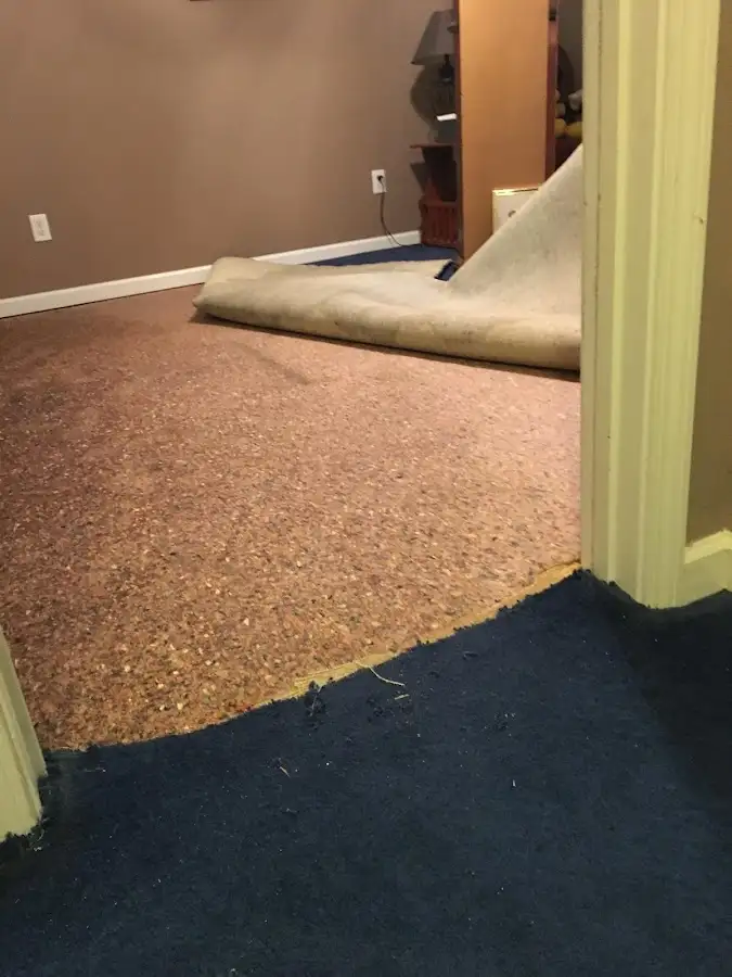 Carpet pad removal revealing water damage during Water Mitigation Services in Lawndale